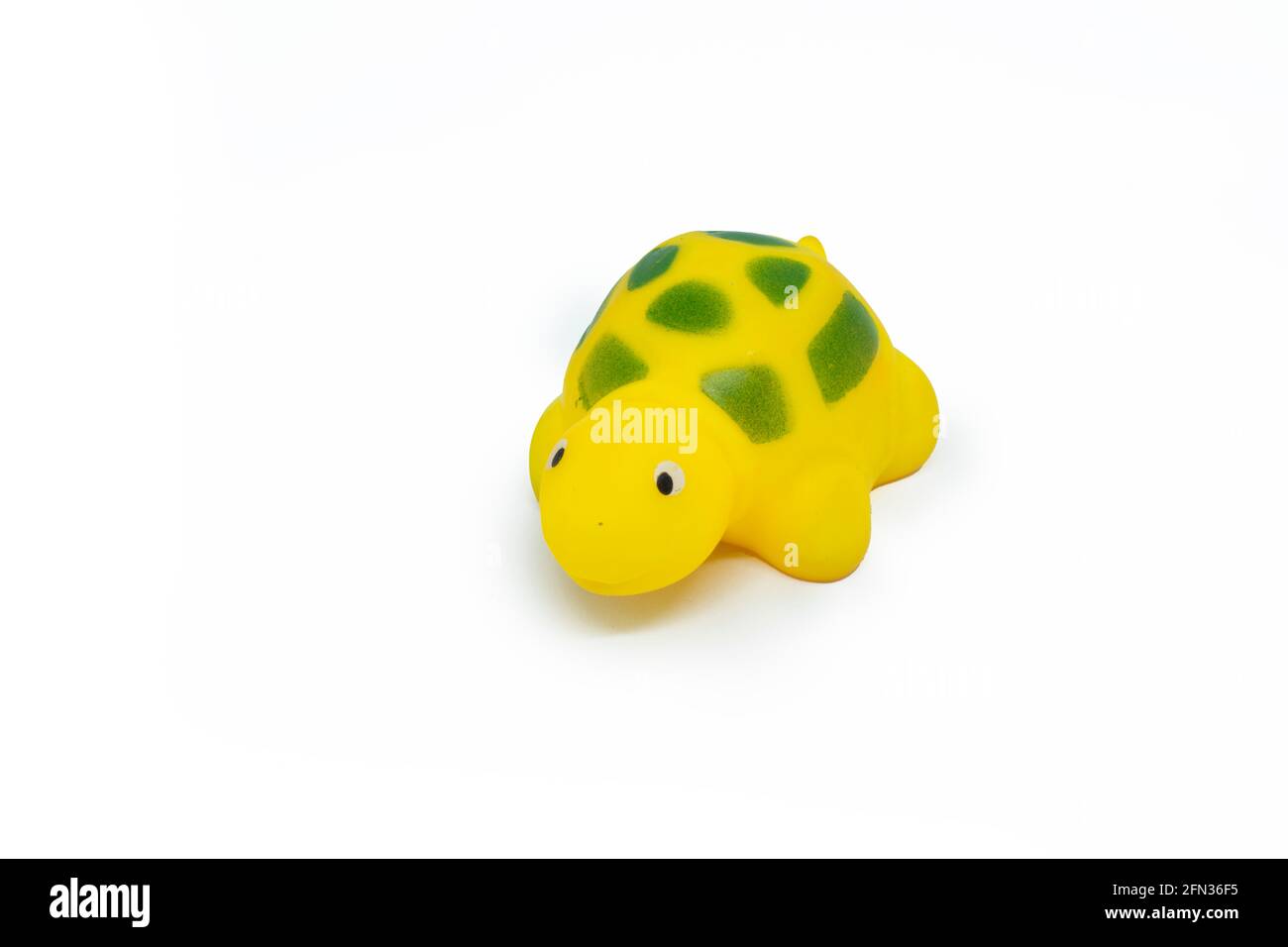 Yellow colored plastic tortoise toy isolated on white background Stock Photo