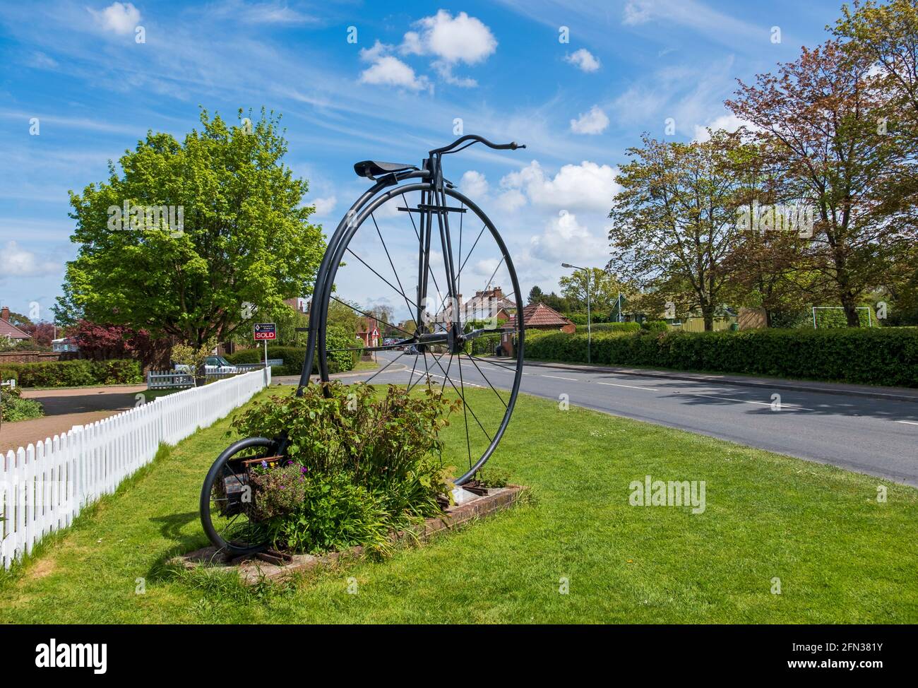 Giant Penny Farthing bicycle at the entrance to Sissinghurst Village, Kent, UK Stock Photo