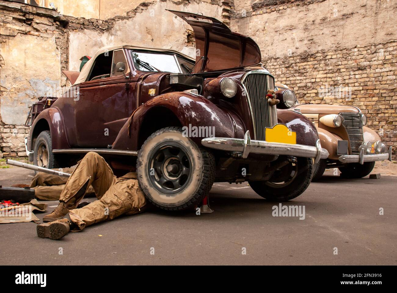 Riga, Latvia June 22 2007: 1937 Chevrolet convertible 4000cc being repaired by mehanic on street at Peking to Paris Rally in Baltic states Stock Photo