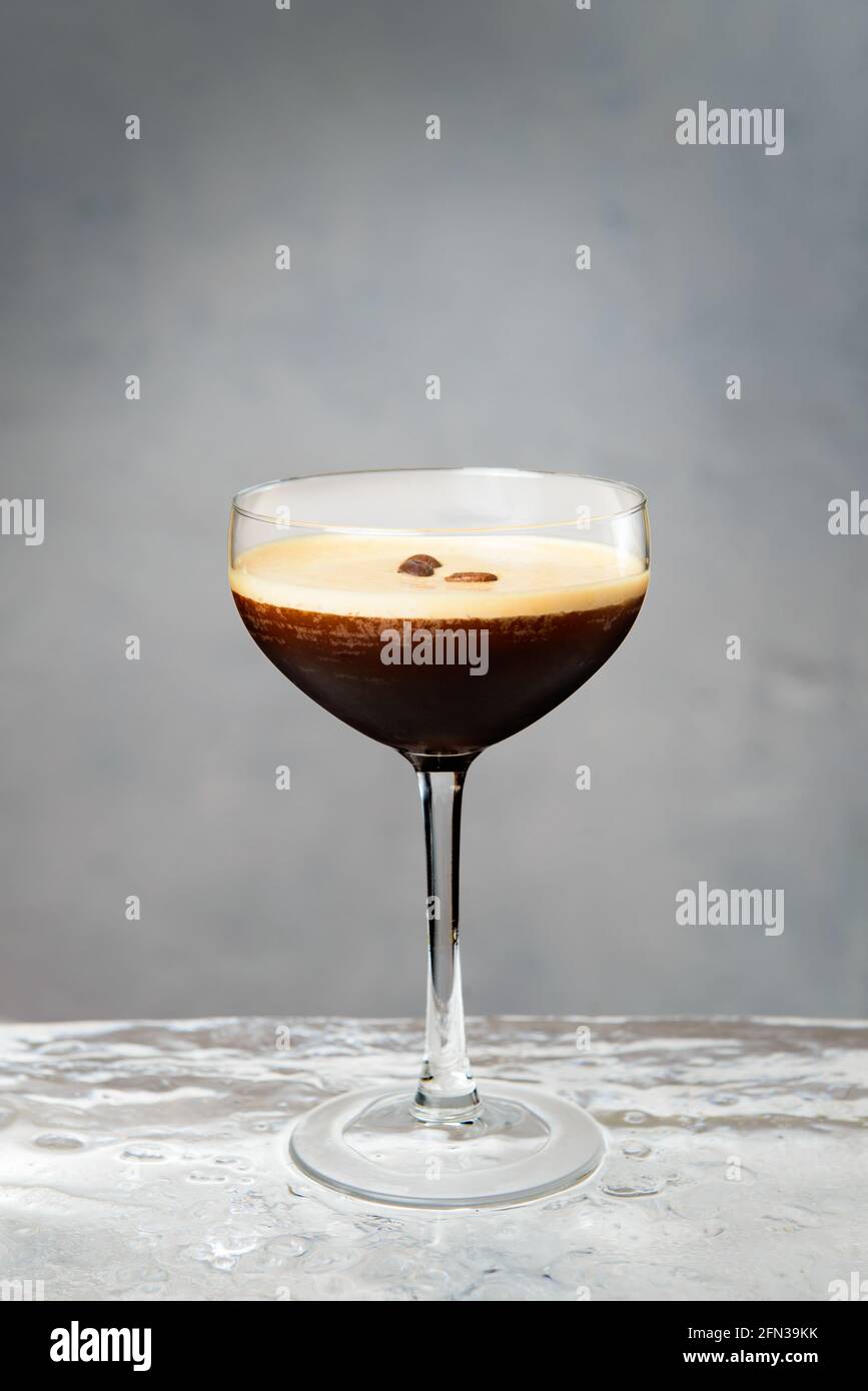 Espresso martini cocktail with brown foam and coffee beans on top
