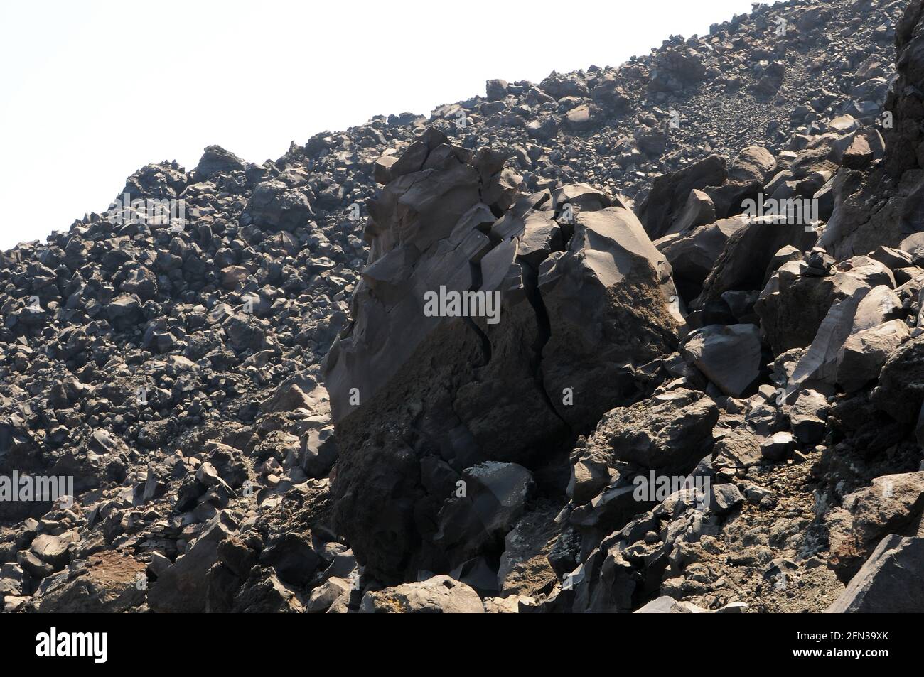 Volcano black rocks with sharp edges and two distinct cracks, textured ...