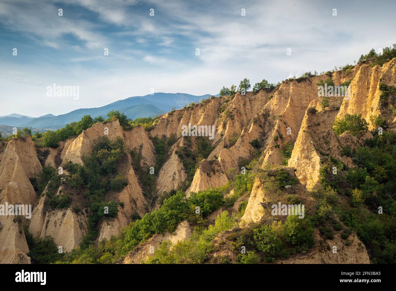 Sunset landscape of the Melnik Pyramids near the village of Rozhen, Southwest Bulgaria. Sand pyramids in the Pirin Mountains, view from Rozhen - Melni Stock Photo