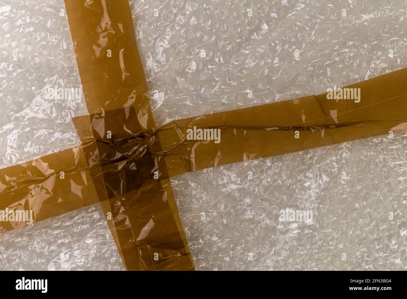Adhesive tape on a bubble wrap. Abstract plastic background. Delivery Concept Stock Photo