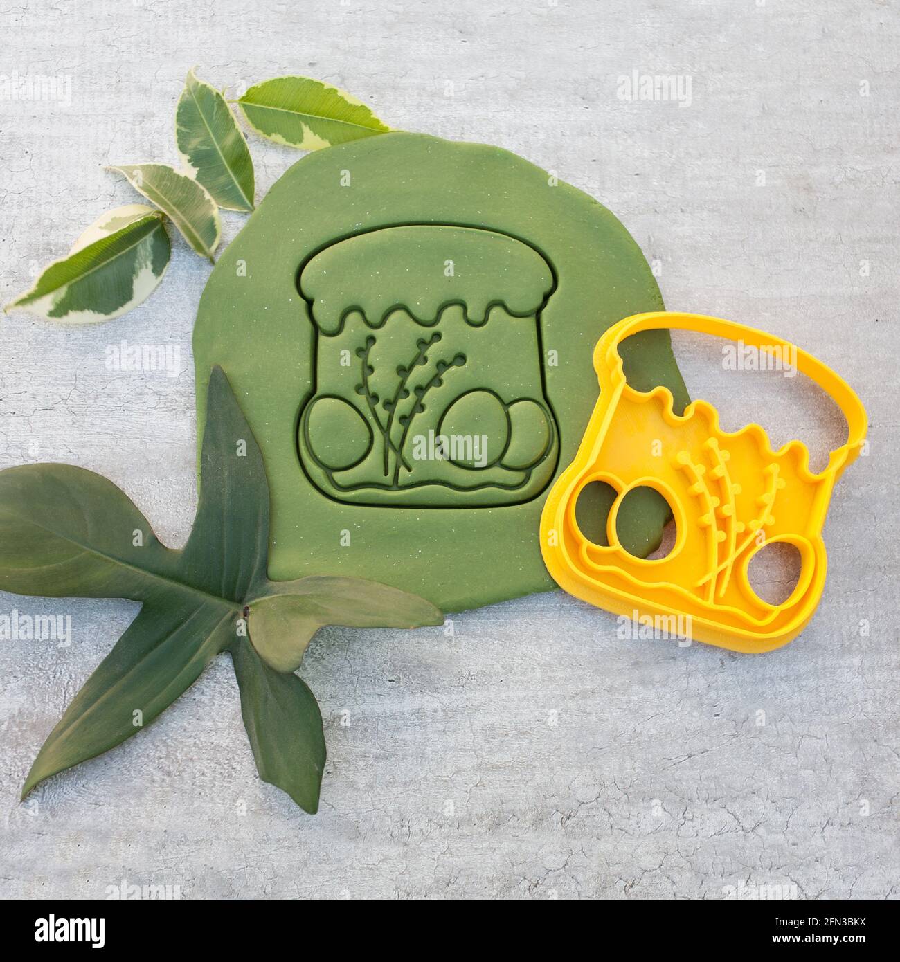 cookie cutter for cutting Easter biscuits on dough for kids Stock Photo