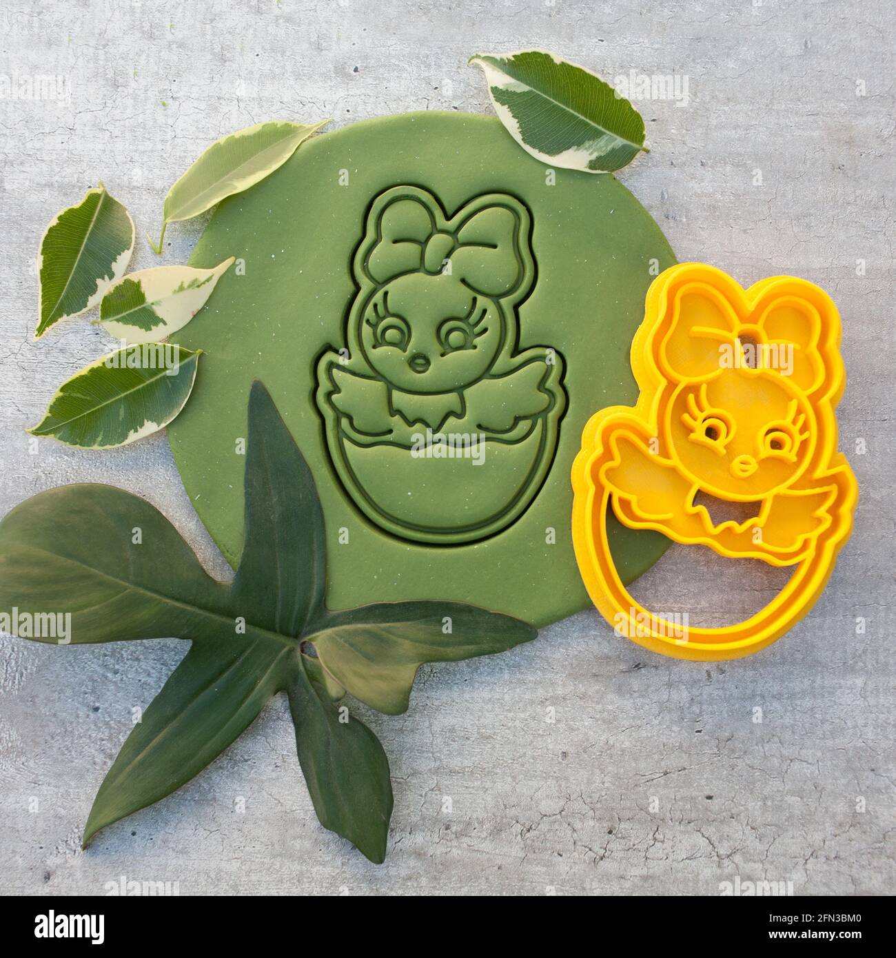 cookie cutter for cutting Easter biscuits on dough for kids Stock Photo