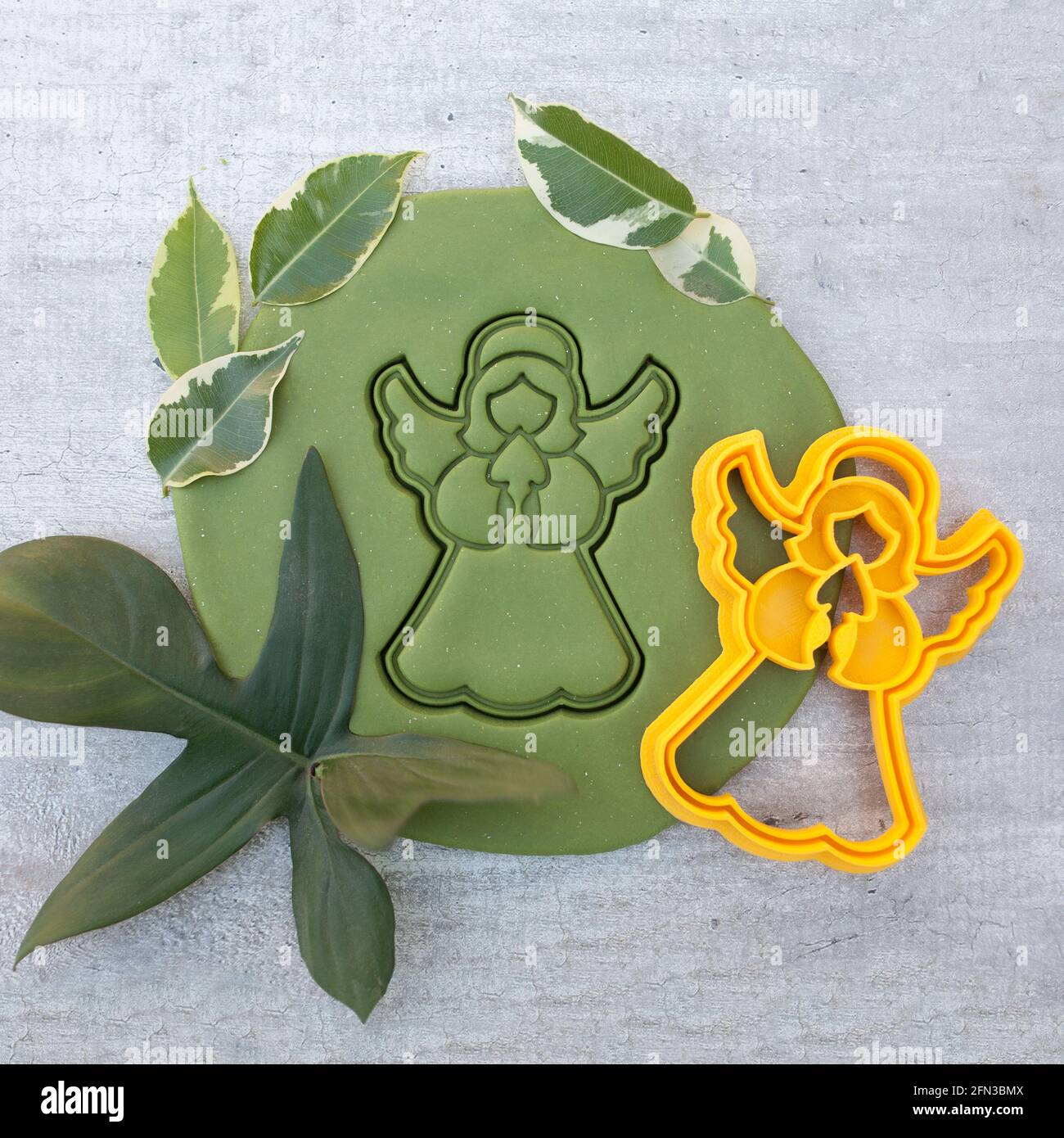 cookie cutter for cutting Easter biscuits on dough for kids Stock Photo