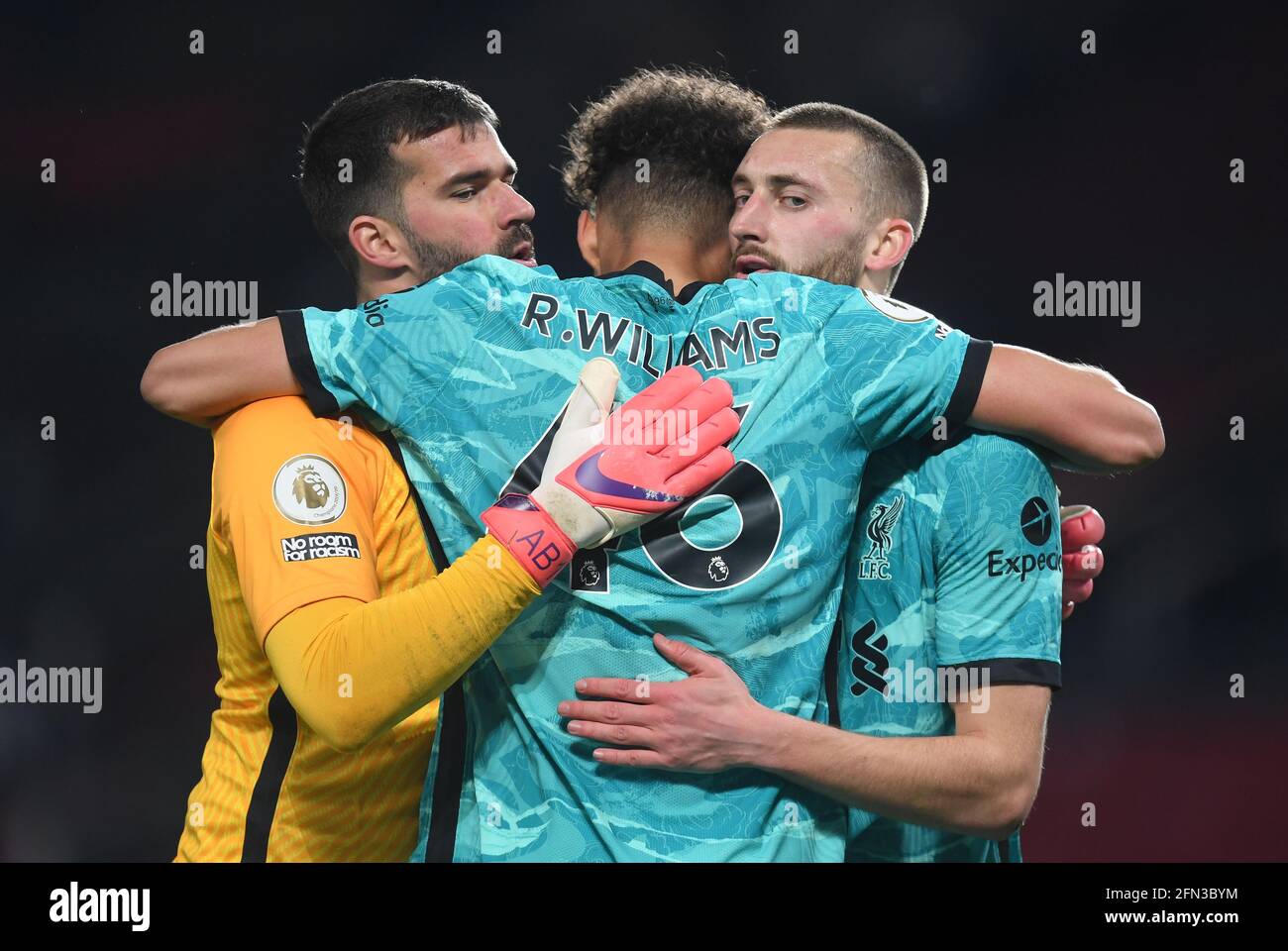 Liverpool goalkeeper Alisson (left), Rhys Williams (centre) and Nathaniel Phillips celebrate after the Premier League match at Old Trafford, Manchester. Picture date: Thursday May 13, 2021. Stock Photo