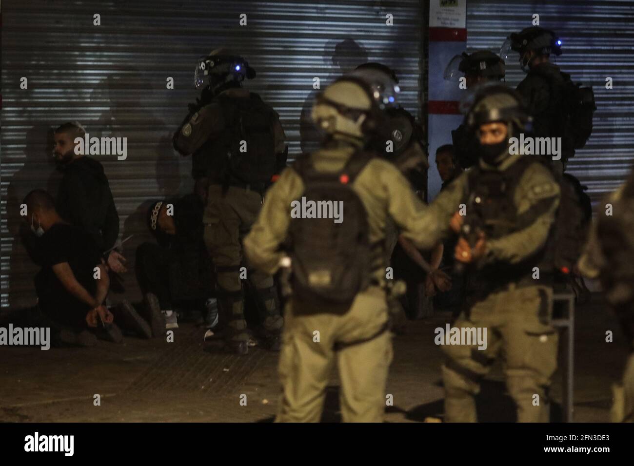 Lod, Israel. 13th May, 2021. Israeli security soldiers detain Arabs