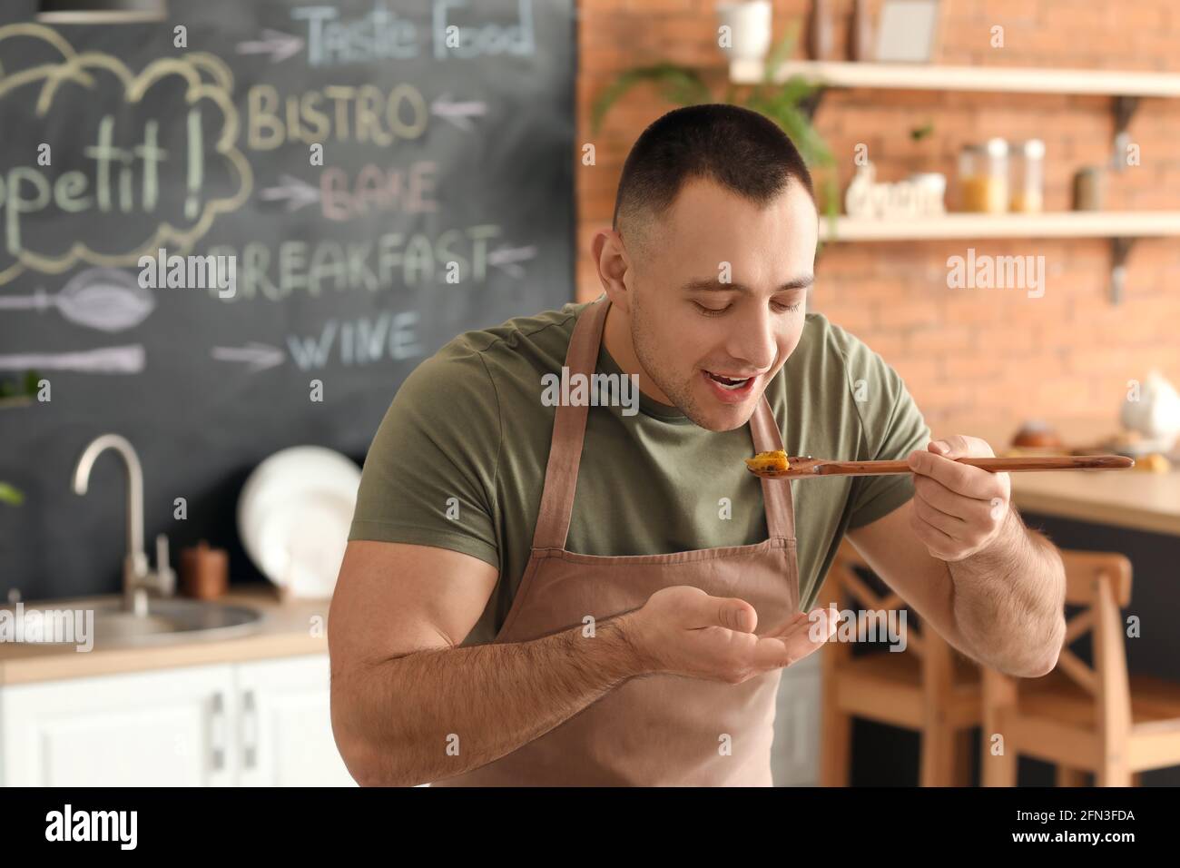 Cook man tasting dish hi-res stock photography and images - Alamy