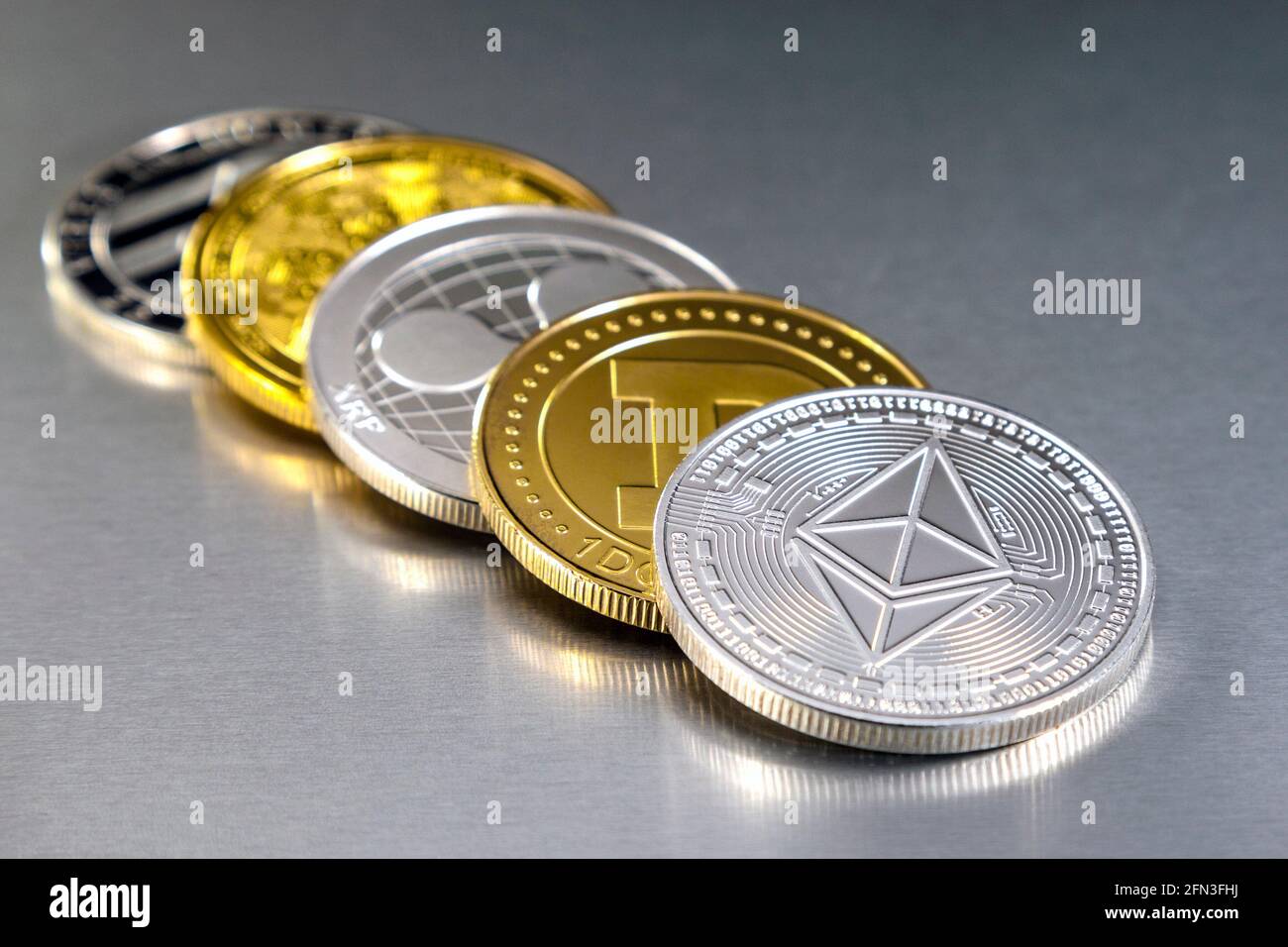Selection of cryptocurrency token alt coins including ethereum classic, dogecoin, ripple, cardano and litecoin Stock Photo