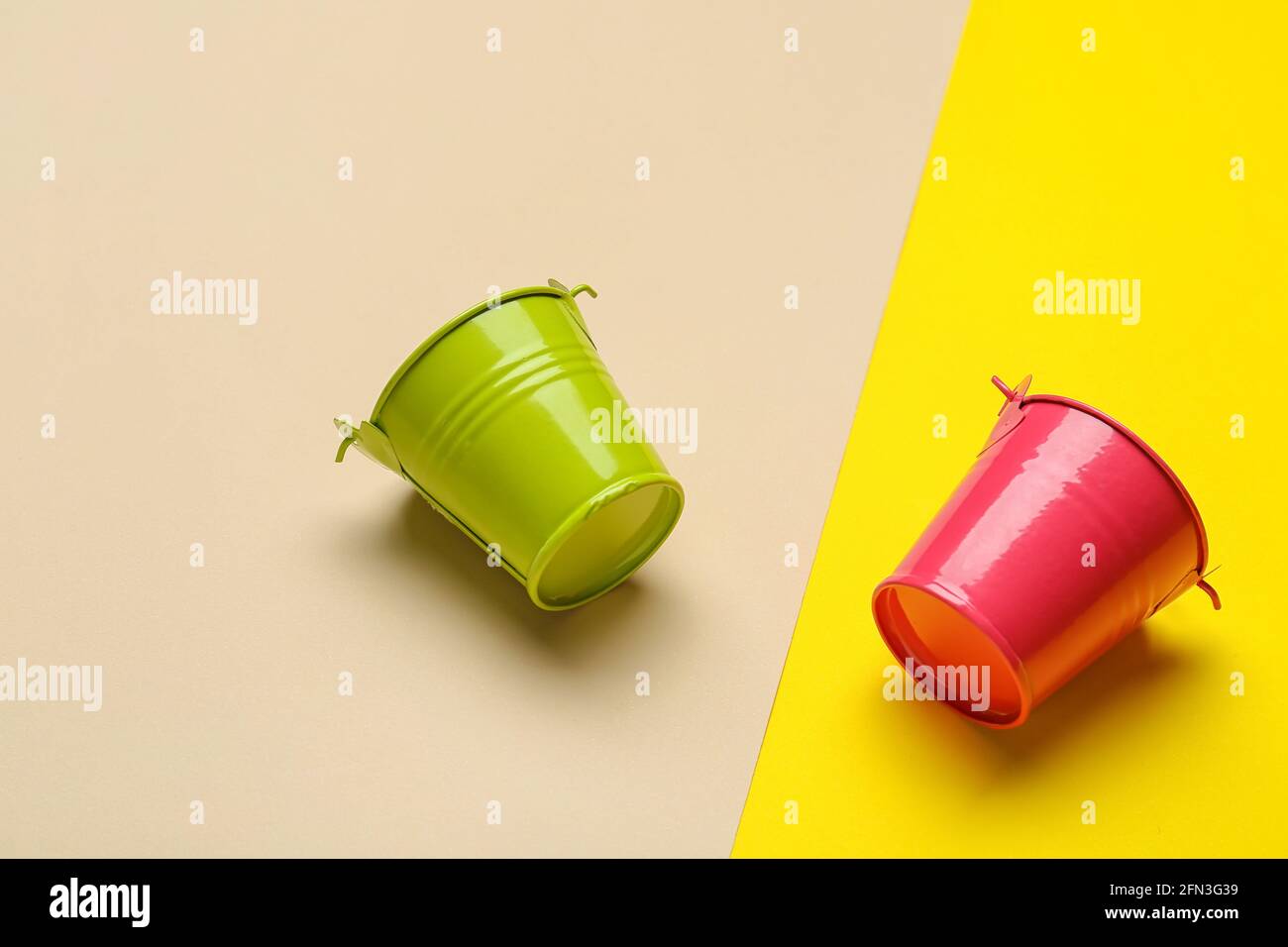 Metal buckets on color background Stock Photo - Alamy