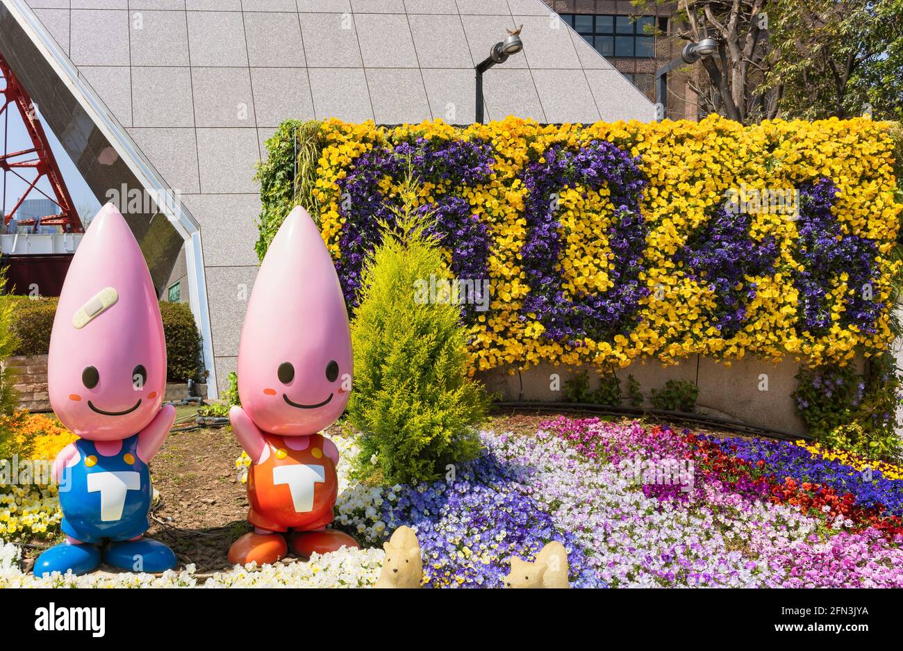 tokyo, japan - april 06 2019: Close up on the Noppon Brothers mascots figurines dressed in overalls at foot of the Tokyo tower to celebrate 60th openi Stock Photo