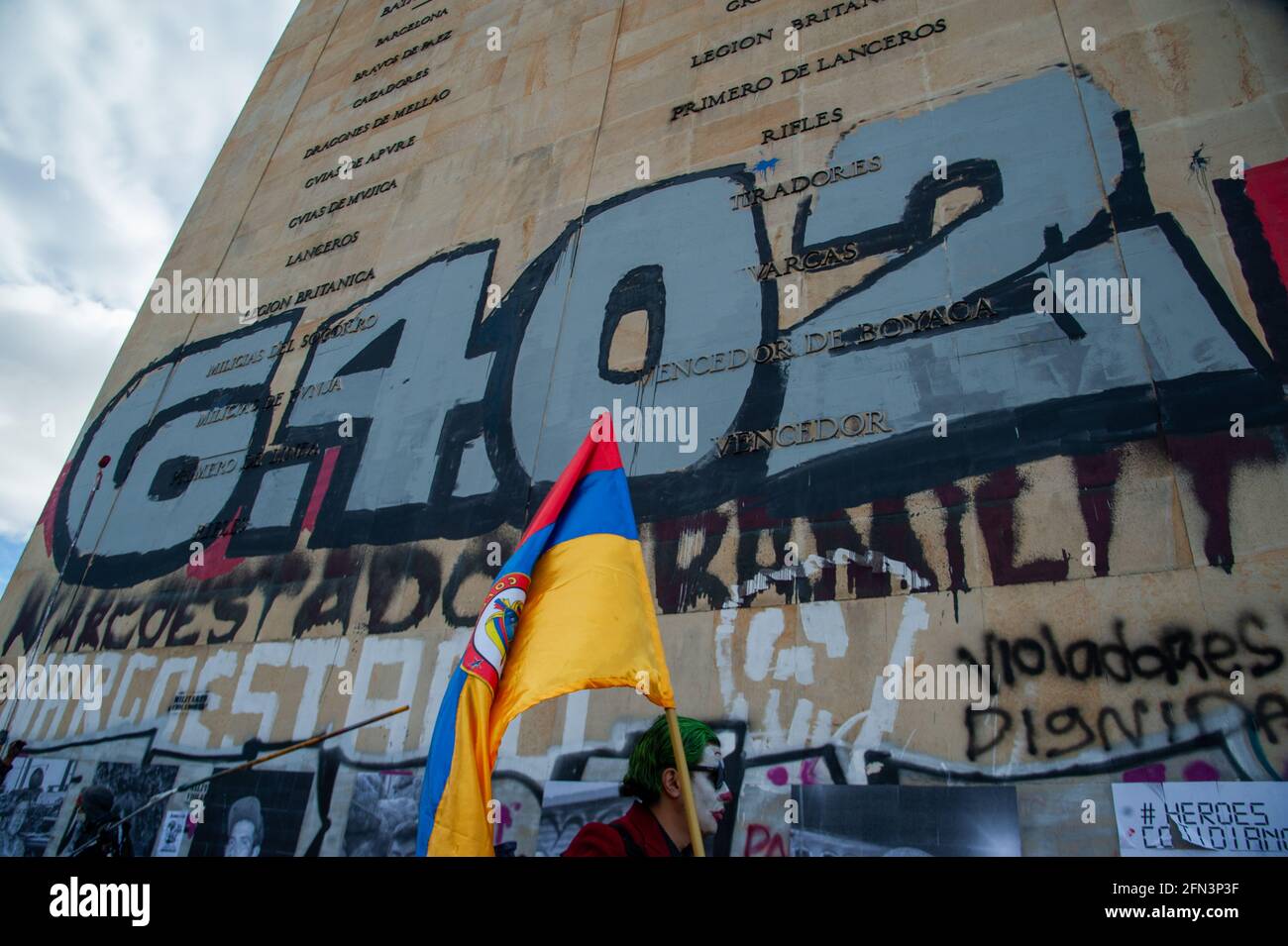 A demonstrator paints the number 6402 (The number of extrajudicial killings in Colombia) as thousands protest in northern Bogota, Colombia on May 12, Stock Photo