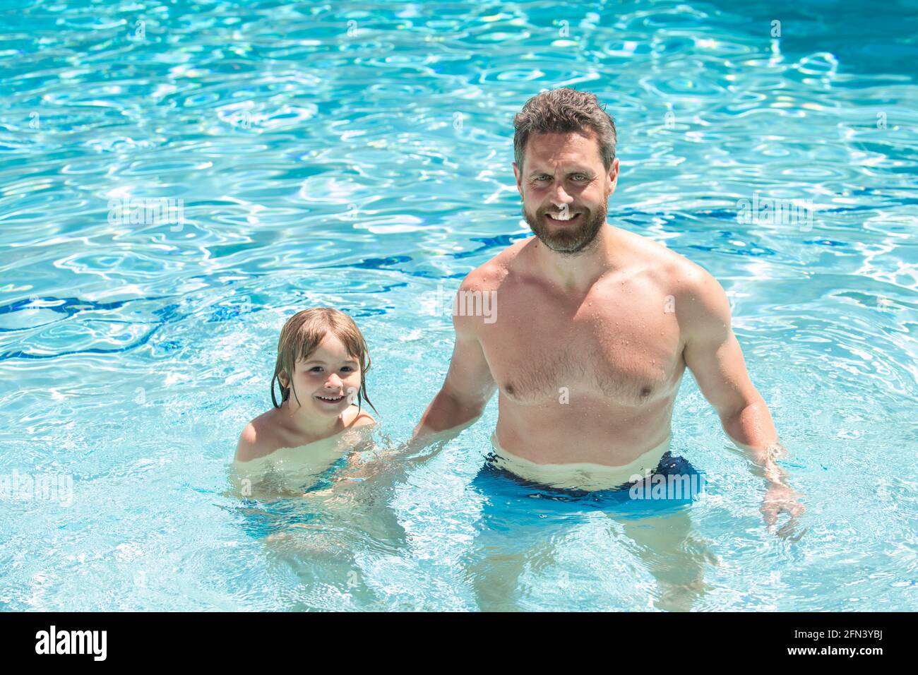 Father and son swimming in pool. Swimming lessons. Family summer