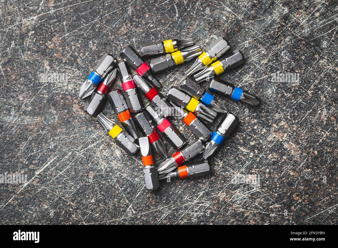 Set of screwdriver bits. Various types of screwdriver heads isolated on black table. Top view