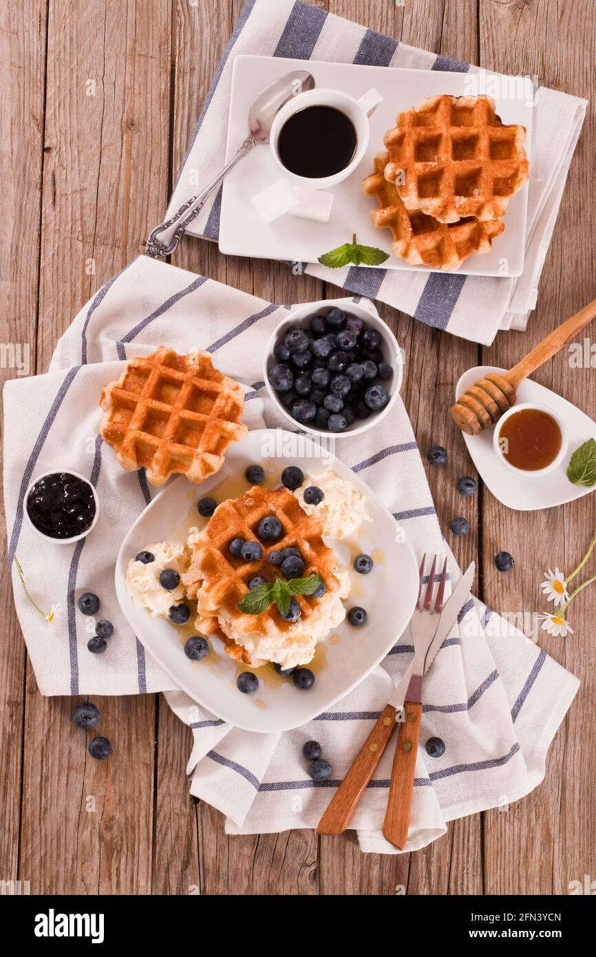 Waffles with blueberries and whipped cream Stock Photo - Alamy