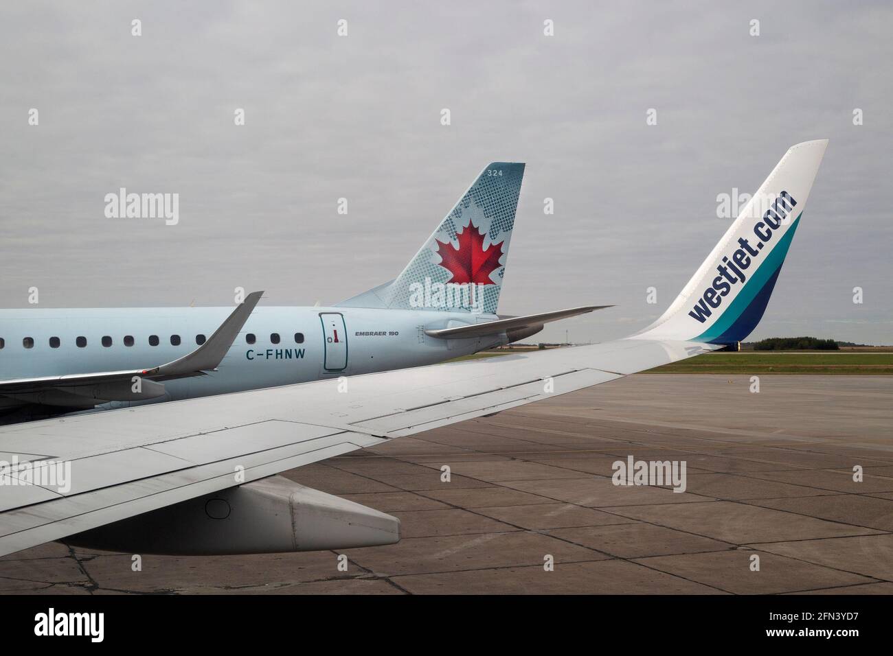 Westjet and Air Canada planes parked on tarmac at John G Diefenbaker airport in Saskatoon Stock Photo