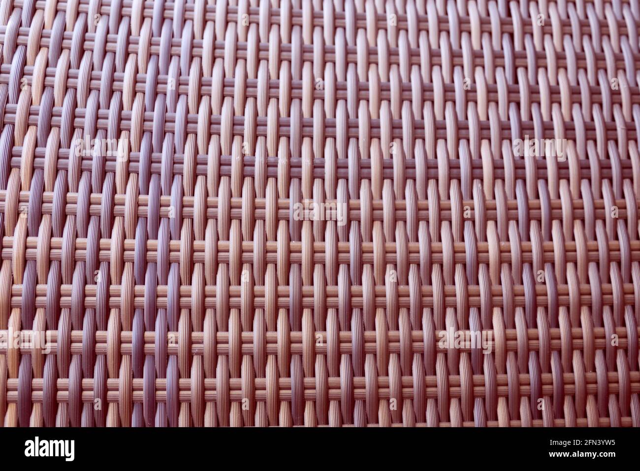 Synthetic rattan texture weaving background as used on outdoor garden furniture. Stock Photo