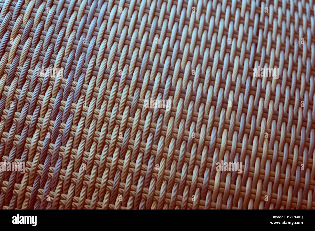 Synthetic rattan texture weaving background as used on outdoor garden furniture. Stock Photo