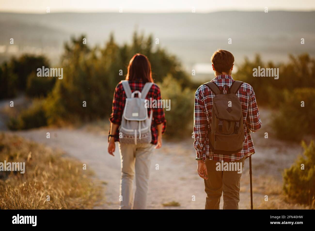Portrait of happy young couple having fun on their hiking trip ...