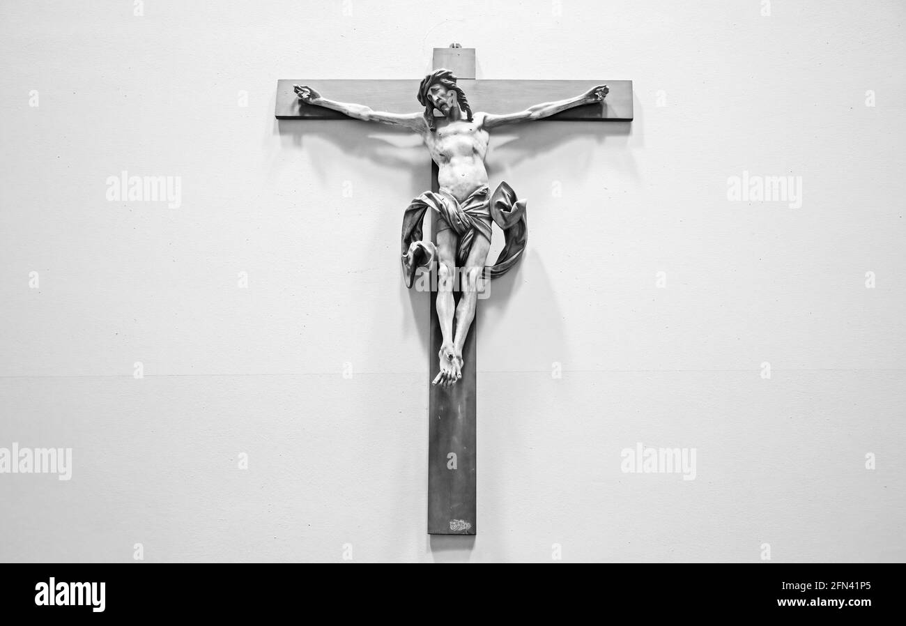 Christian background with crucifix of Jesus Christ on gray distressed concrete wall with copy space Stock Photo