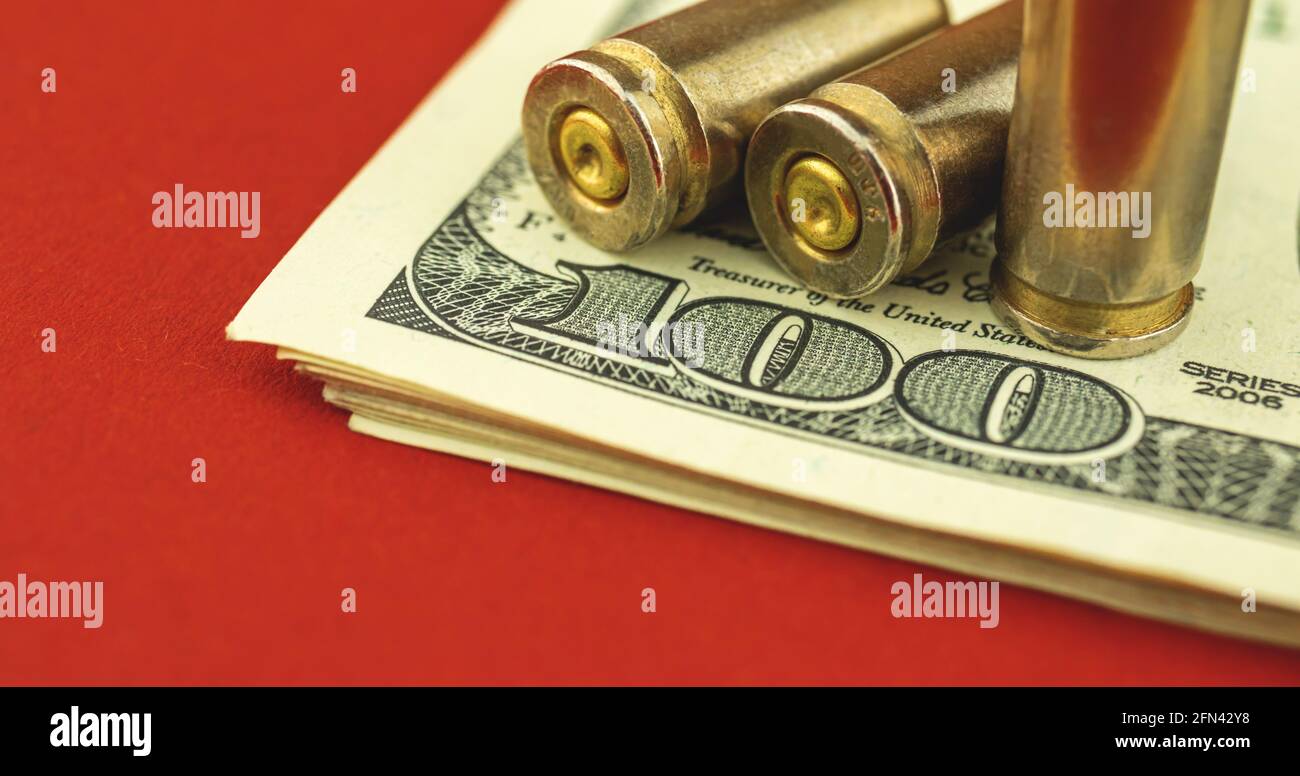 Banner illegal of ammunition trade, sale of weapons, concept of financing terrorism, UD dollar bill and bullet on the background Stock Photo