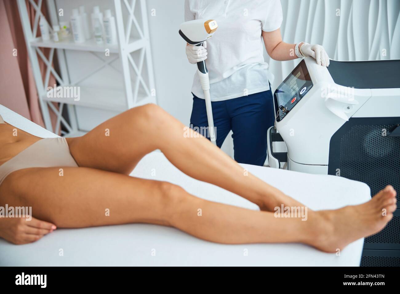 Doctor preparing a woman for a laser hair removal treatment Stock Photo