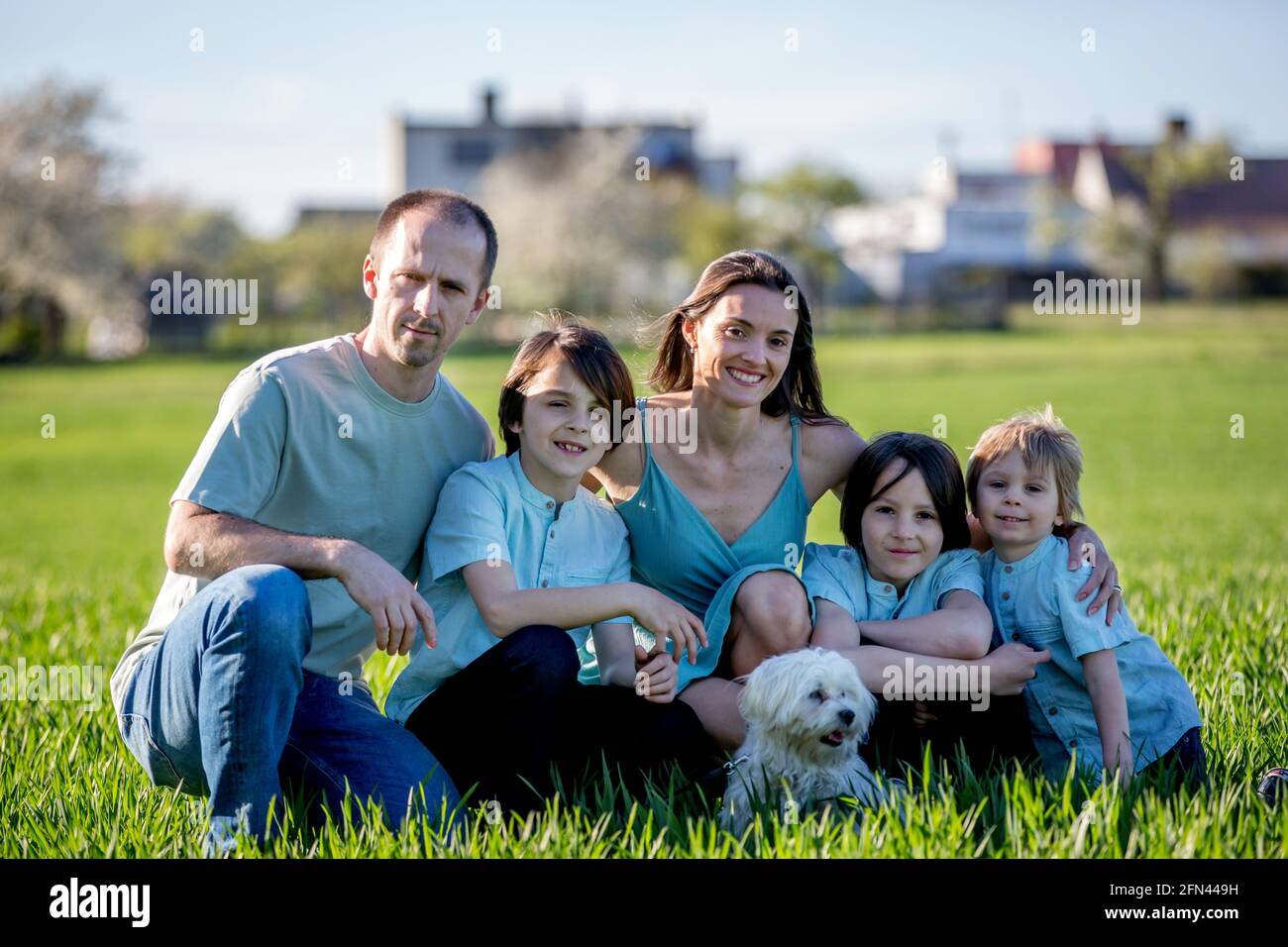 Beautiful family with kids, mom, dad, three boys and a dog, playing in ...