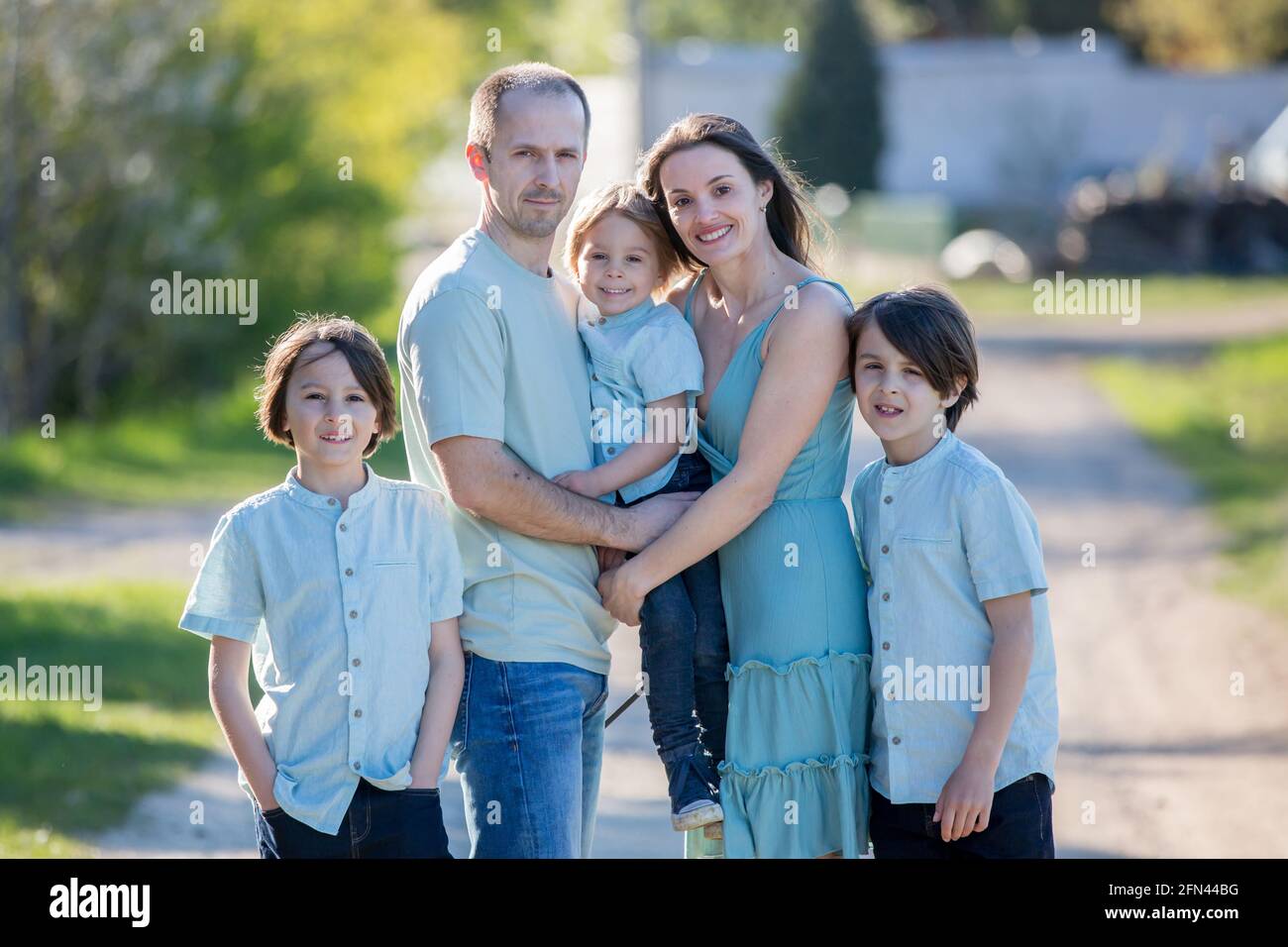 Beautiful family with kids, mom, dad, three boys and a dog, playing in ...