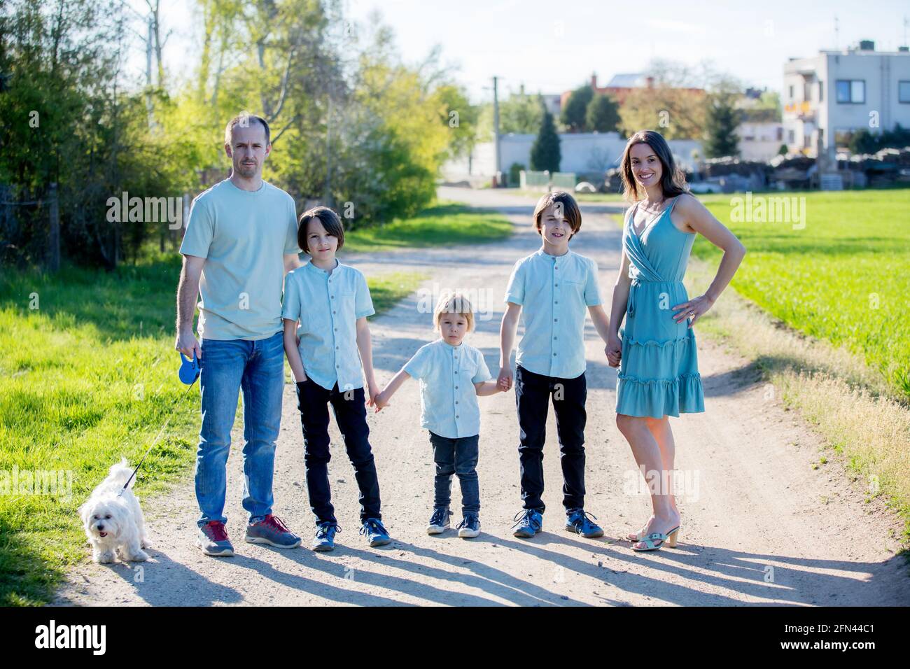beautiful-family-with-kids-mom-dad-three-boys-and-a-dog-playing-in