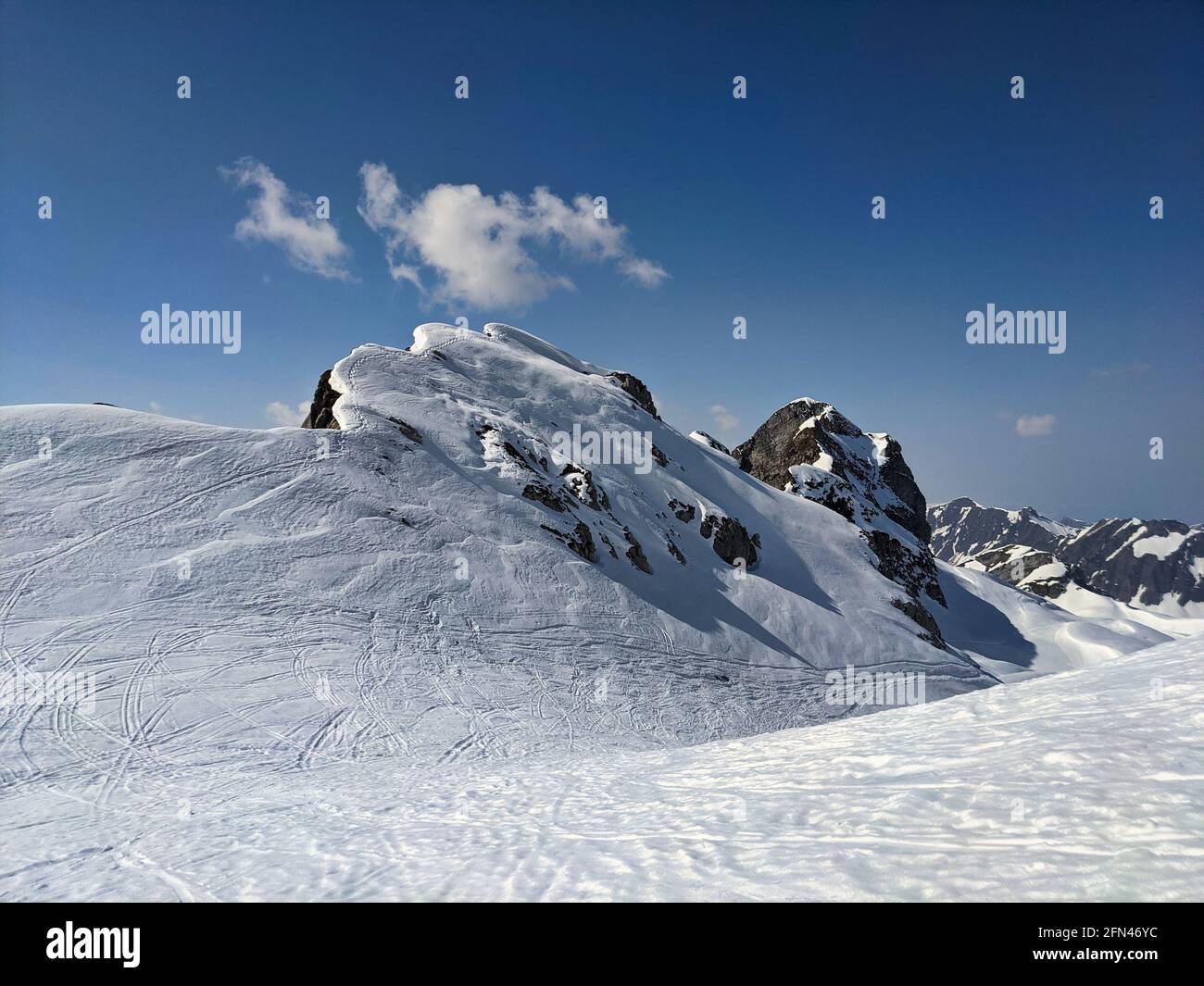 snowy mountain peaks in winter above kloental in the canton of glarus.Ski mountaineering on the mutteristock.Switzerland Stock Photo