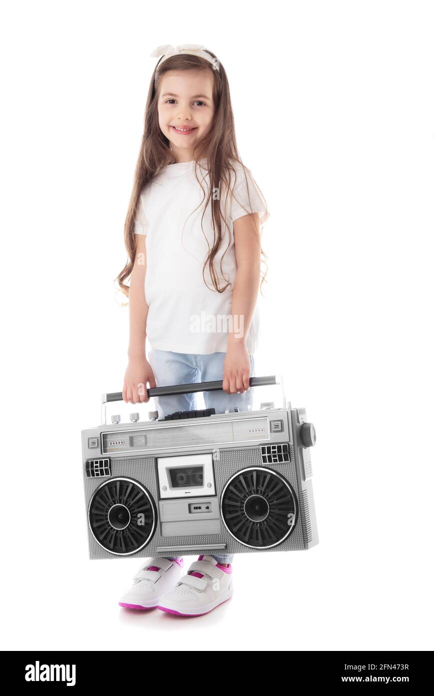 Young hip hop girl listening music on boombox retro radio, ghetto blaster, isolated on white background Stock Photo