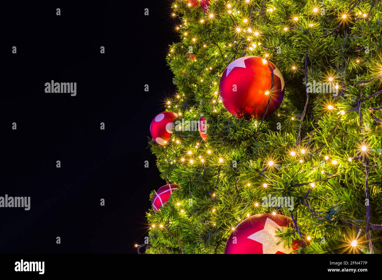 Christmas tree with colorful balls and gift background Stock Photo - Alamy