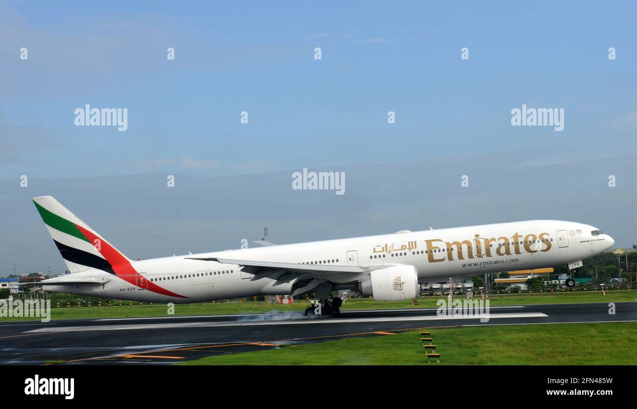 An Emirates aircraft landing in Manila, Philippines. Stock Photo