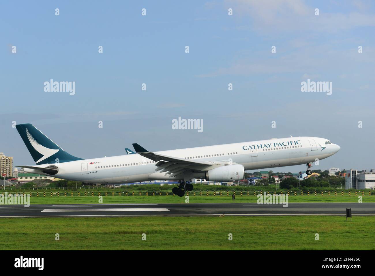 A Cathay Pacific aircraft landing in Manila, The Philippines. Stock Photo
