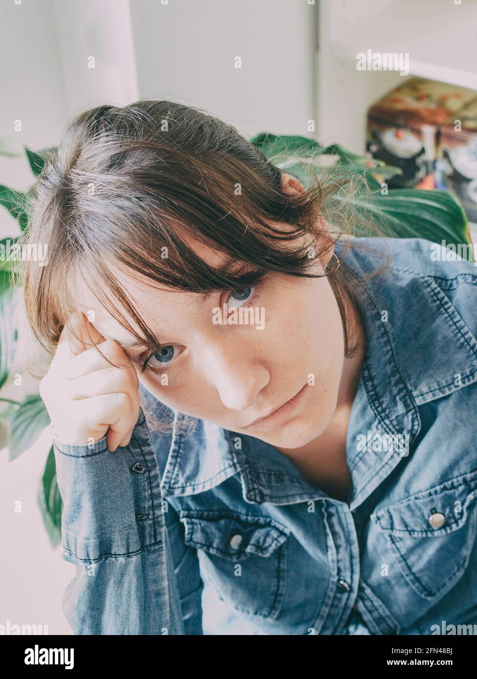 portrait of a girl with blue eyes and casual clothes looking at camera Stock Photo