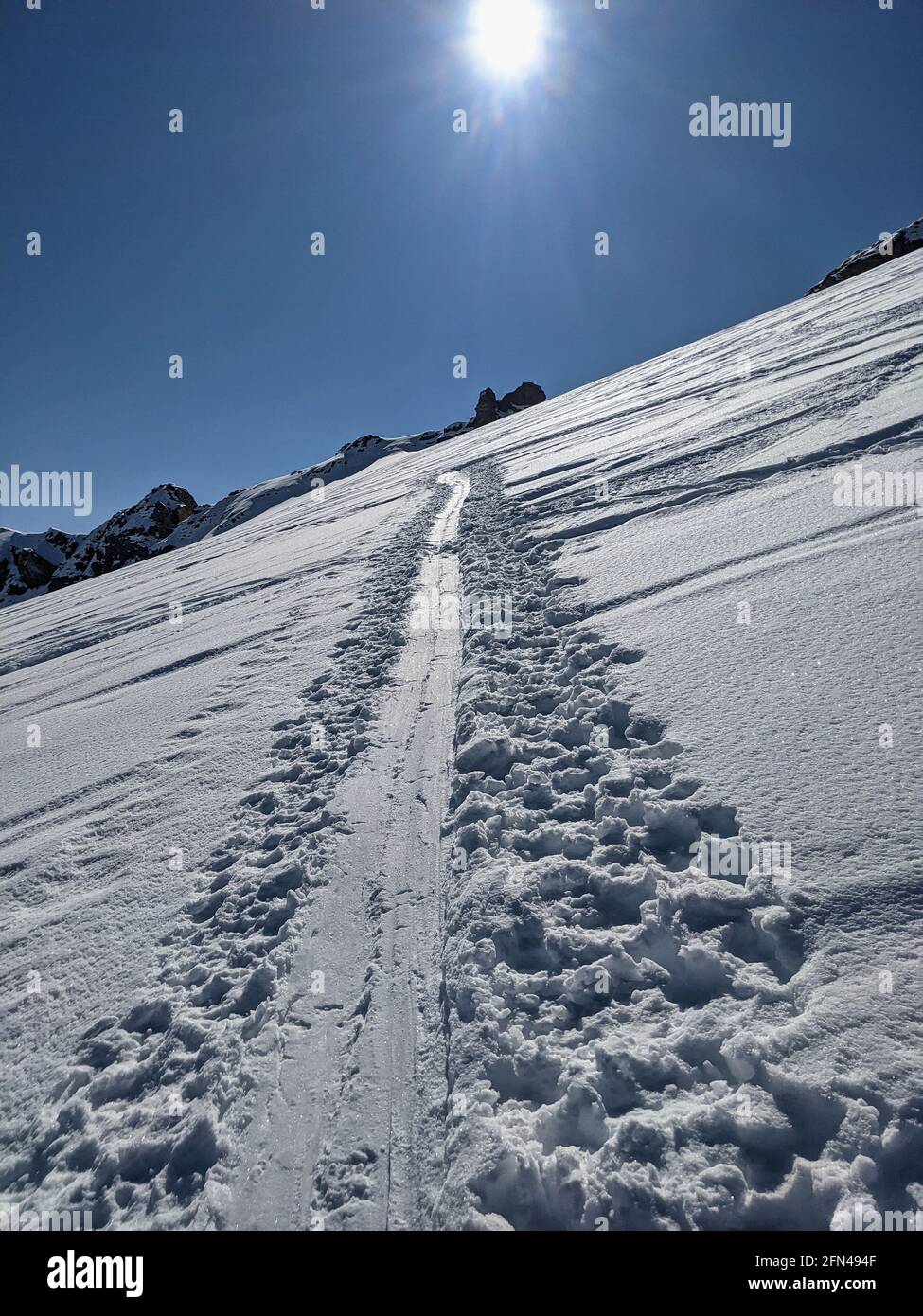 ski touring track in a grandiose winter landscape with high mountains. Mountaineering in the swiss alps. Gemsfairenstock Stock Photo