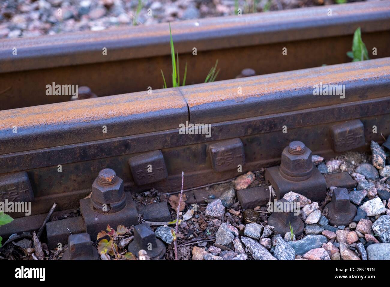 Helsinki / Finland - MAY 13, 2021: Closeup of a retro-style railway track with wooden sleepers. Stock Photo