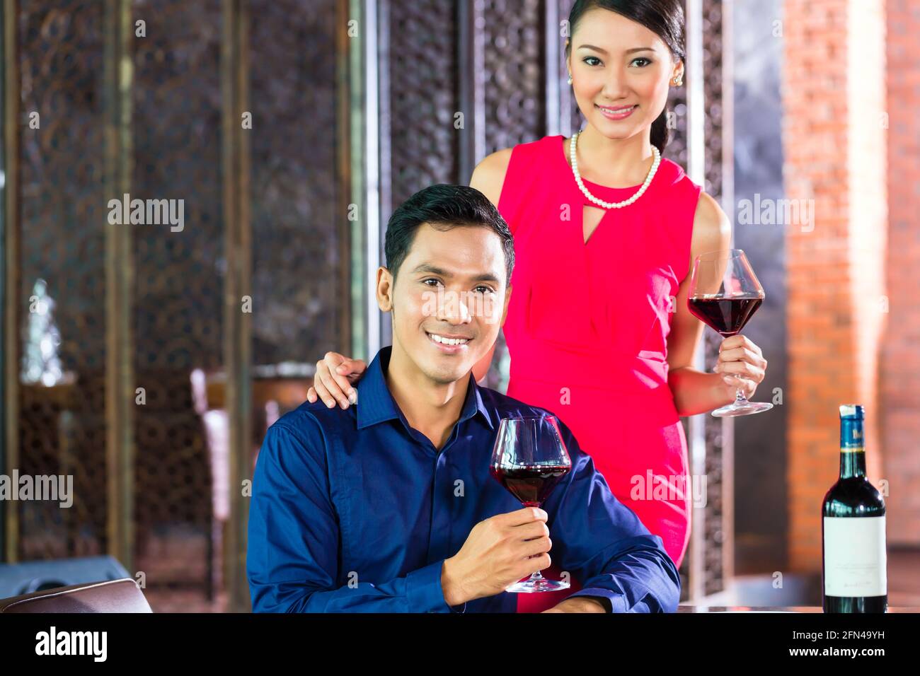 Portrait of Asian couple with a glass of red wine Stock Photo - Alamy