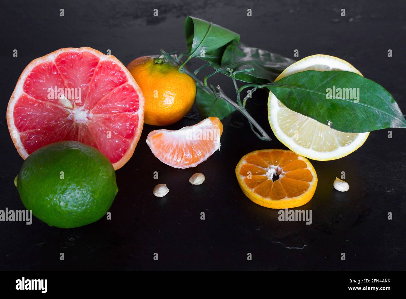 fresh citrus fruits on a black background close-up Stock Photo