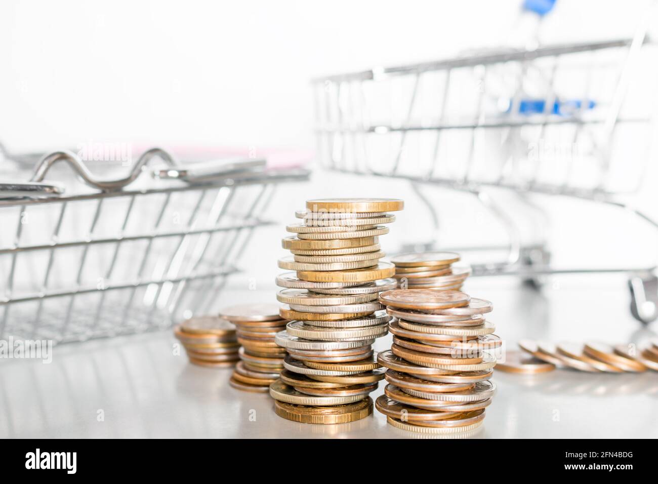 coins and food carts concept inflation, rise in price, poverty Stock Photo