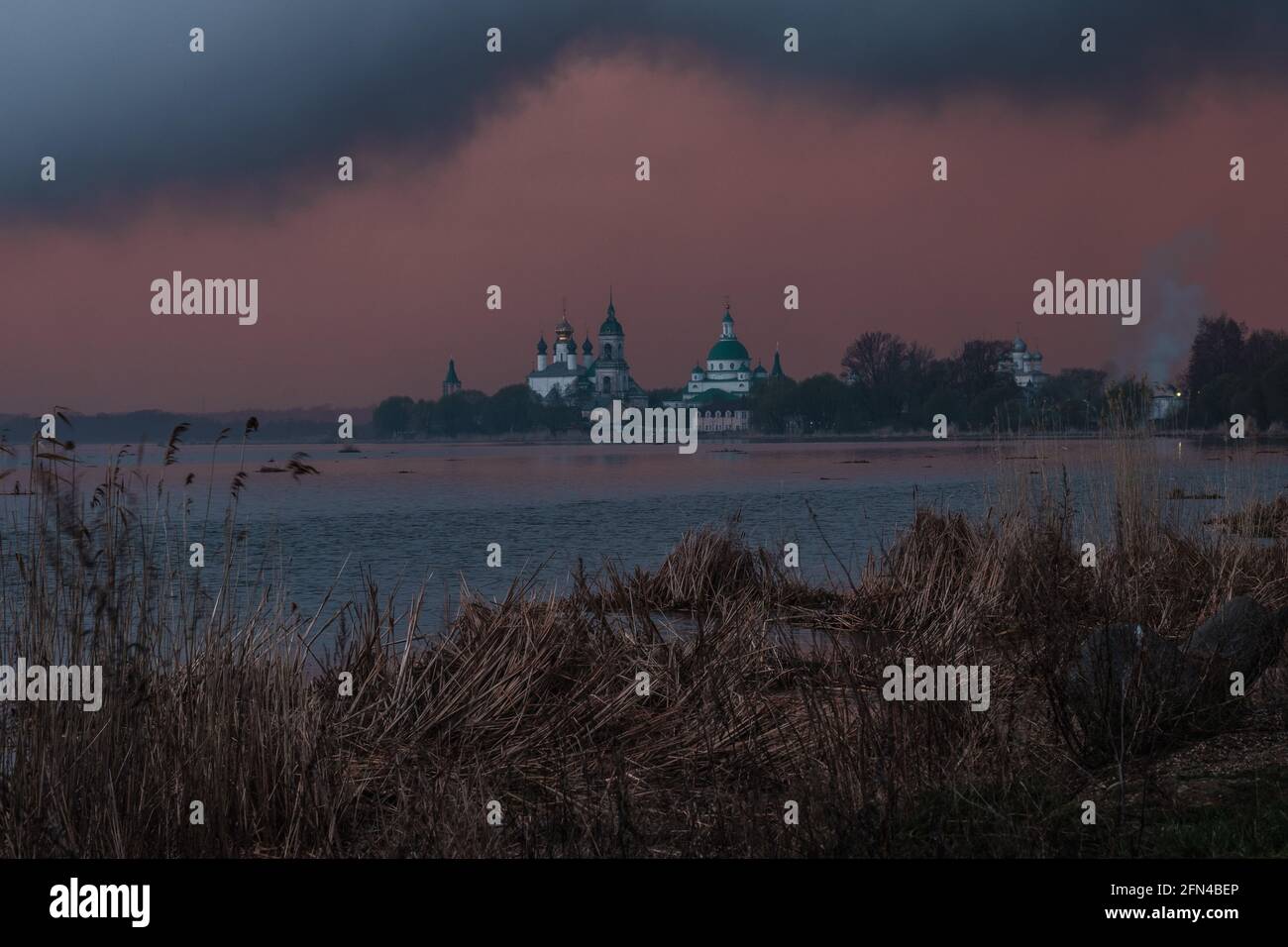 View of Spaso-Yakovlevsky Monastery in Rostov Veliky from Nero's lake on a sunset. Stock Photo