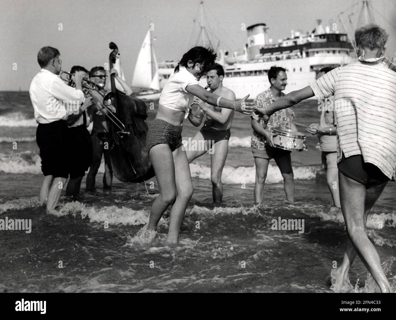 vacation / holiday, beachlife, music group and dancing people, standing in water, 1960s, ADDITIONAL-RIGHTS-CLEARANCE-INFO-NOT-AVAILABLE Stock Photo