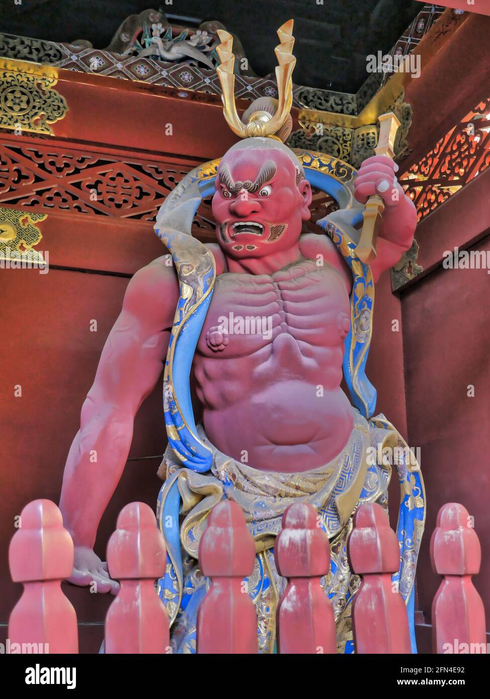 Statue of a Shinto deity in a Japanese mausoleum. Red statue of Nio, the guardian god. Buddhism, spirituality and Japanese tradition. Stock Photo