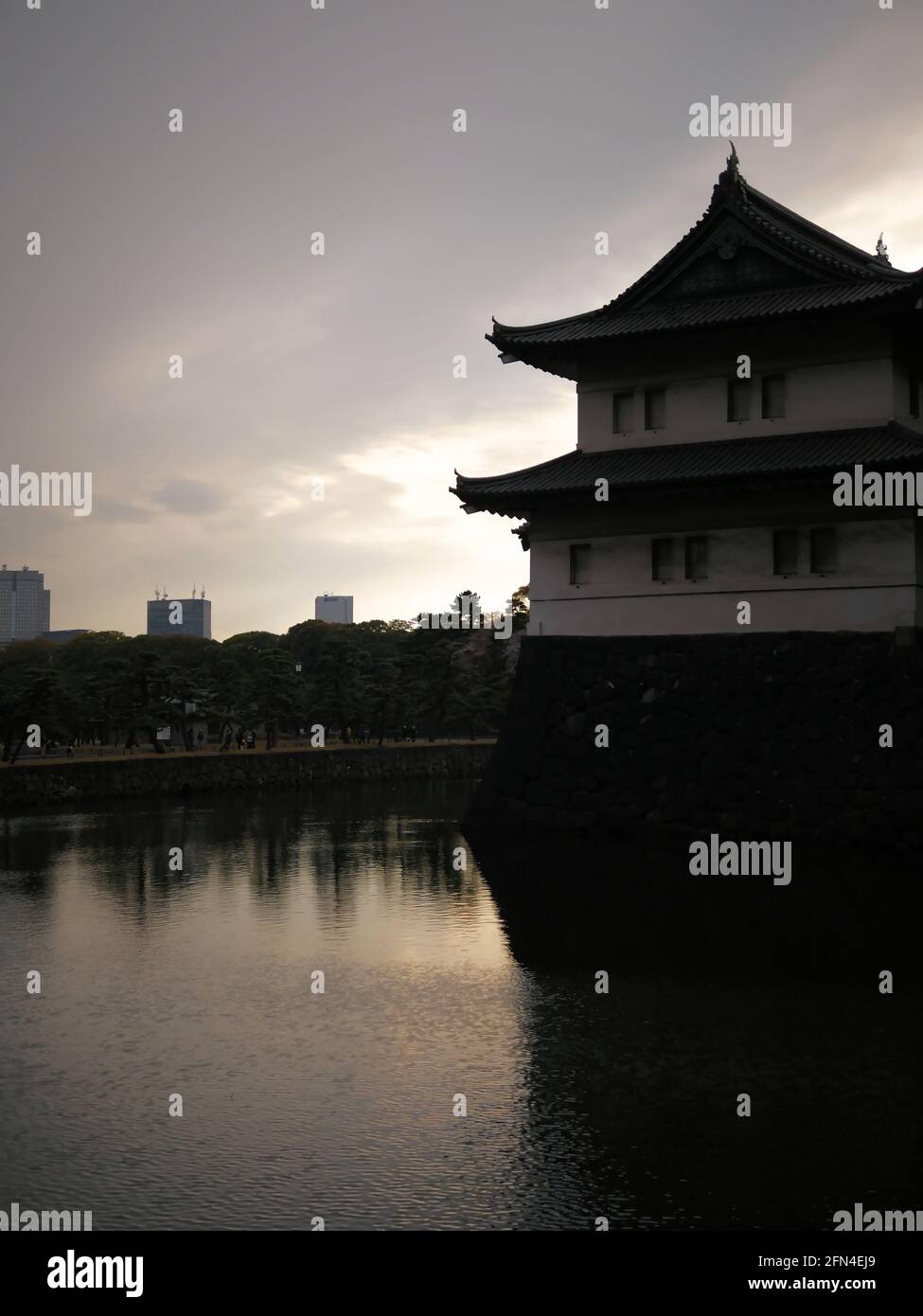 The famous Tokyo Imperial Palace at sunset. Main official residence of the Emperor of Japan. Moat surrounding the Fushimi-yagura watchtower. Stock Photo