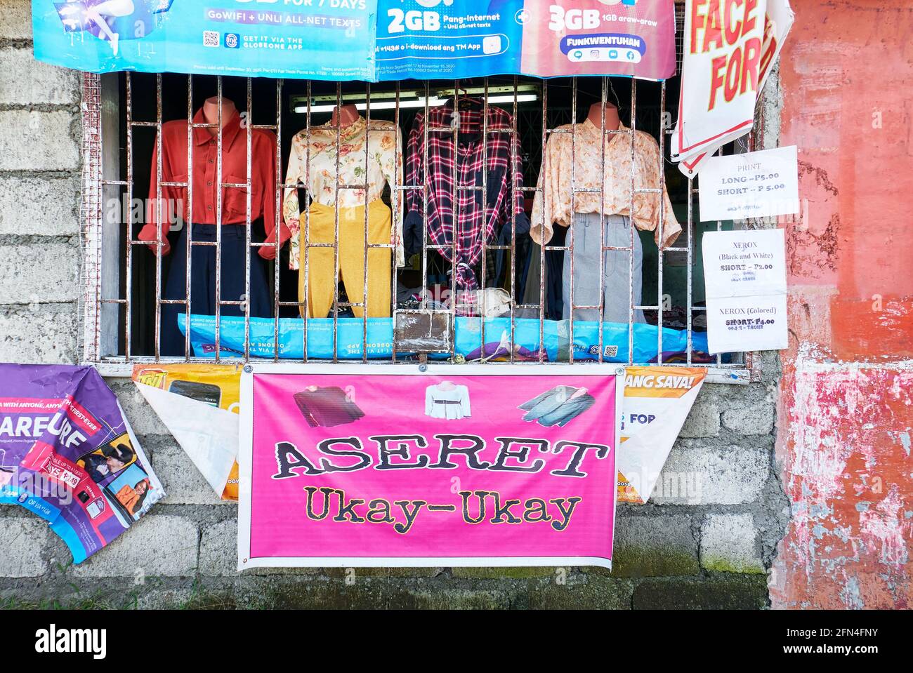An Ukay-Ukay window store selling used clothes as an extra income to overcome the poverty during the covid pandemic times in the Philippines Stock Photo