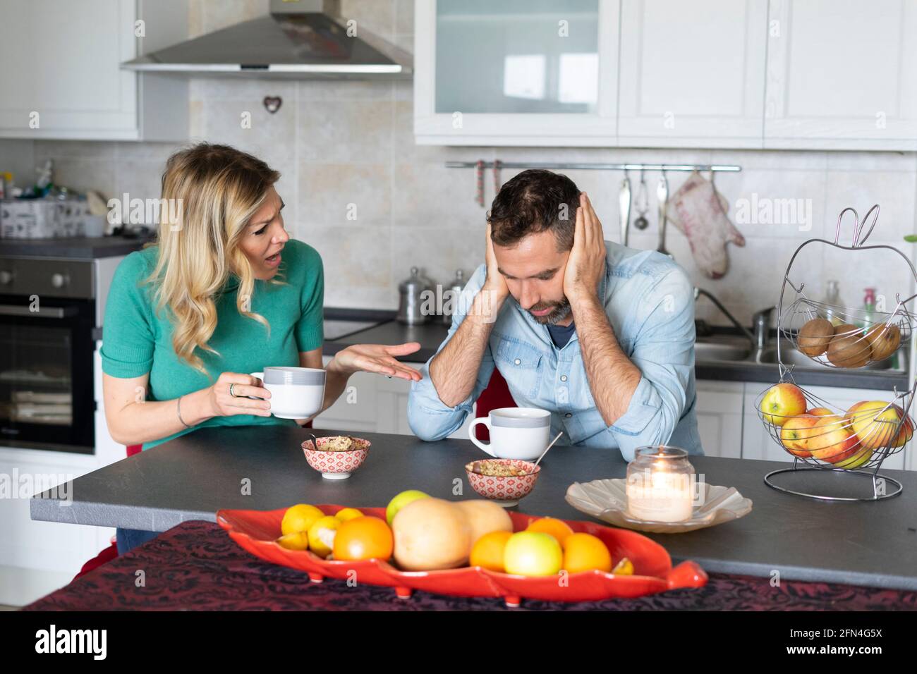 Suspicious woman looks at her worried boyfriend. Dramatic look of a