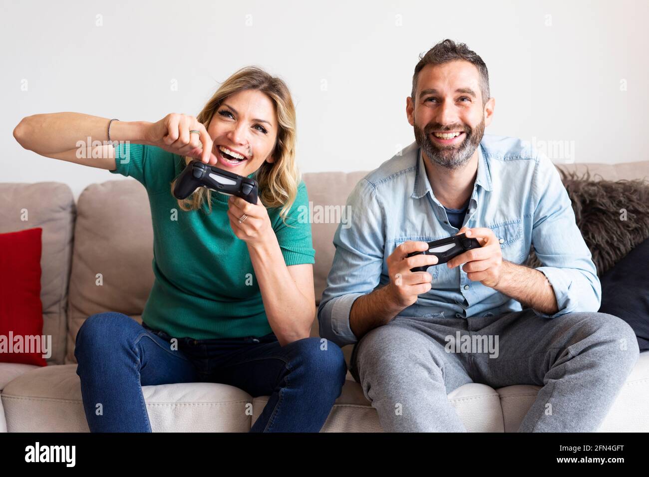 Joyful couple winning video games with joystick on console in studio.  Boyfriend and girlfriend playing online game with controller to win,  feeling happy and relaxed with leisure activity Stock Photo - Alamy