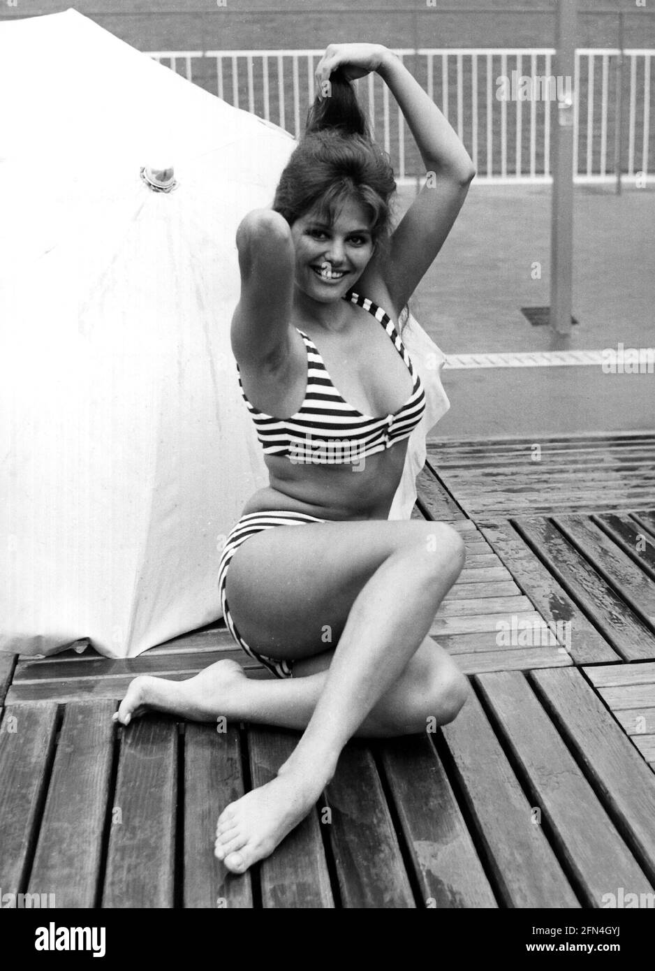 Cardinale, Claudia, * 15.4.1938, Italian actress, wearing bikini, sitting, 1950s, 50s, striped, ADDITIONAL-RIGHTS-CLEARANCE-INFO-NOT-AVAILABLE Stock Photo