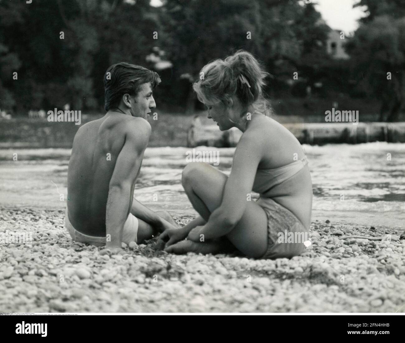 people, couples, 1960s, lovers sitting at a lake, 1960s, ADDITIONAL-RIGHTS-CLEARANCE-INFO-NOT-AVAILABLE Stock Photo